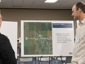 James Kennedy of of Morrison Hershfield speaks with a resident of Niverville at an open house to discuss the future build-out of Highway 311.