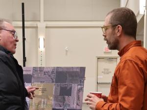 Tom Janzen of SMM speaks with a local resident.