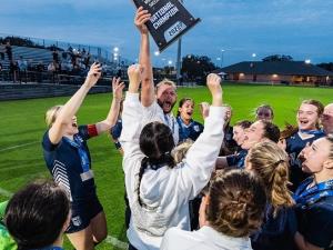 The Providence Pilots women's soccer team celebrate winning the NCCAA national championship.