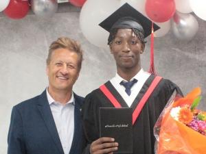 Graduate Michael Katotoka receives the Ron R. Schuler Citizenship Award.