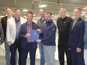 Nighthawks board members Bryan Trottier and Ray Dowse, Mayor Myron Dyck, MLA Ron Schuler, Councillor Nathan Dueck, Nighthawks Head Coach Kelvin Cech, Deputy Mayor John Funk, and Nighthawk board members Tom Kleyson and Carl Fast.