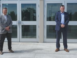 Dr. Kenton Anderson, President of Providence University, and Niverville Mayor Myron Dyck announce a partnership agreement for use of the CRRC fieldhouse.