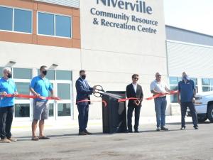 The ribbon-cutting: Councillor Chris Wiebe, Councillor Nathan Dueck, Mayor Myron Dyck, MLA Ron Schuler, Councillor Kevin Stott, and Deputy Mayor John Funk.