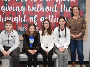 Members of SWAG, alongside teacher Laura van den Brul, on the school’s new bench.