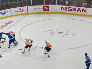 The Jets defend against the Philadelphia Flyers at Bell MTS Place.