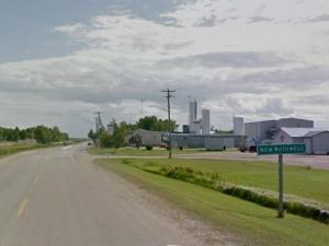 Edna Vogt and Carol Tesluk, about to perform the ribbon-cutting ceremony with the town’s new mural in the background.