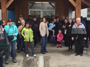 A crowd of eager shoppers gathers outside the thrift store on a chilly Tuesday morning.