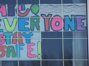 People are posting messages of support in the windows of their homes.