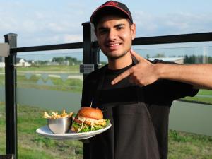 Harkirat Khattra with his signature Maharaja Chicken burger at Smitty's Niverville.