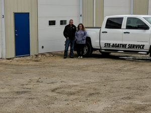 Alain and Rachel Robert in front of their nine-bay shop.
