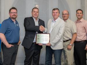 Councillor Chris Wiebe, CAO Eric King, CAMA board member Rodney Sage, Mayor Myron Dyck, and councillors Kevin Stott, Nathan Dueck, and John Funk.