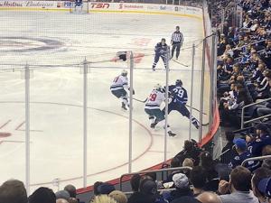 Players jockey for the puck at Bell MTS Place