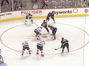 Mark Scheifele takes a face-off at the BellMTS Place.