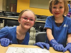 Brownies Erin Beaton and Ryleigh Wachniak attend STEM Day at the University of Manitoba