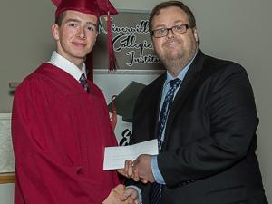 Riley Hiebert accepting The Citizen bursary from editor Evan Braun