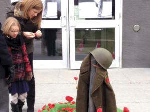 Attendees at Niverville's 2015 Remembrance Day service laying their poppies