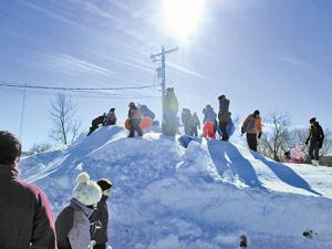 Kids climb the toboggan hill at Niverville's Family Fun Day