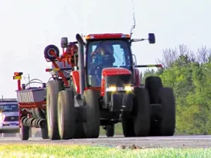 Farm equipment moving along the highway, a common sight from August to October