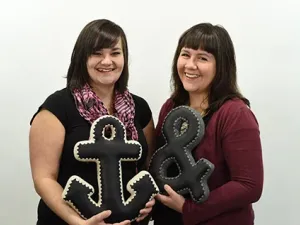 Bethany Speers and Melodie McMahon holding their handmade pillows