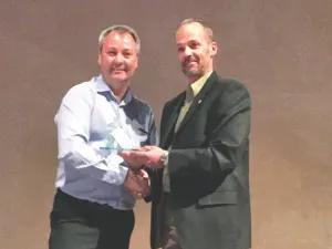 Greg Fehr accepts his award from Jim McMillan