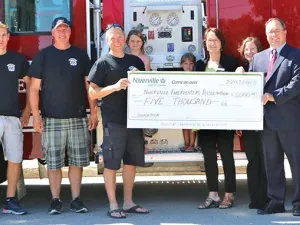 Ron Ashcroft of NCU presents cheque to Deputy Fire Chief Brad Wasilinchuk