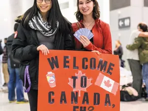 Canadians await the arrival of the first plane of Syrian refugees at Toronto's Pearson International Airport