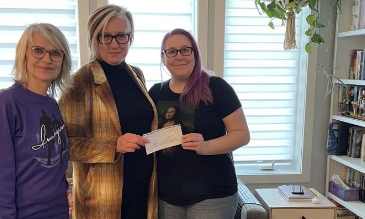 Mona Stott and Mona Dumont present Imagine's donation to Nadine Huberdeau.