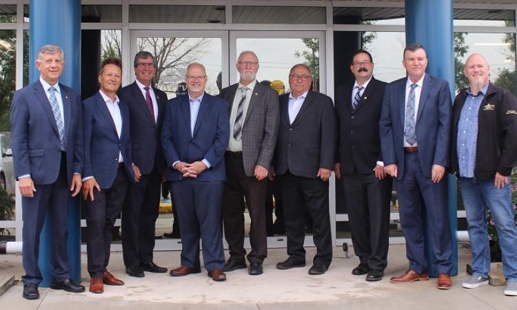 Officials gather in Niverville to announce a major government funding initiative for a cooperative wastewater treatment plan.