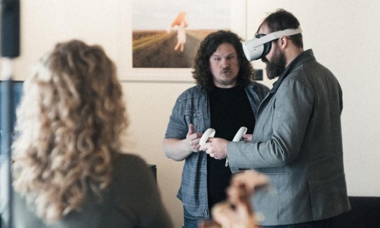 Rory Hiebert helps new-to-VR users explore his online art gallery.