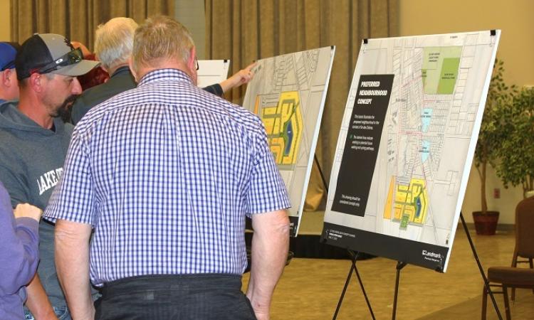 Residents look over plans for new development in Île-des-Chênes.