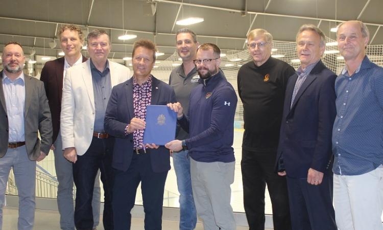 Nighthawks board members Bryan Trottier and Ray Dowse, Mayor Myron Dyck, MLA Ron Schuler, Councillor Nathan Dueck, Nighthawks Head Coach Kelvin Cech, Deputy Mayor John Funk, and Nighthawk board members Tom Kleyson and Carl Fast.
