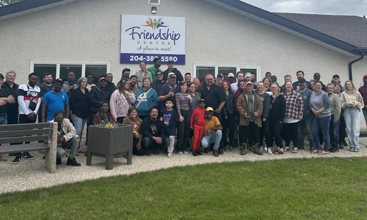 The Niverville fair committee gathers with the Wonder Shows crew on the Wednesday before the fair.