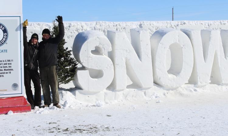 Angie and Clint in front of their record-breaking snow maze near St. Adolphe.
