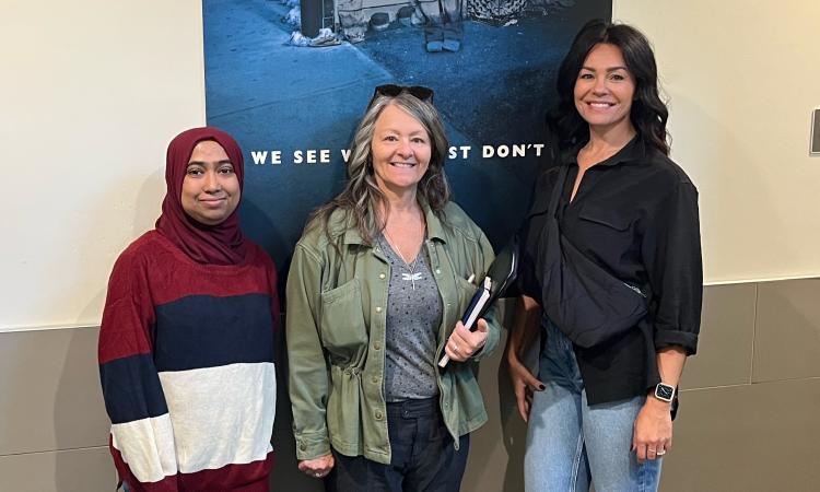 A staff member of the Salvation Army Winnipeg Centre of Hope gives a tour to Leona Doerksen (middle) and Lisa Clark of Lisa Clark Designs (right).