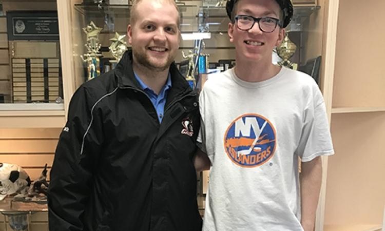 Coach Colin David and Riley Weir, wearing the Cavaliers hardhat.