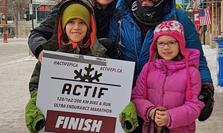 Joao is greeted by his family at the end of the race