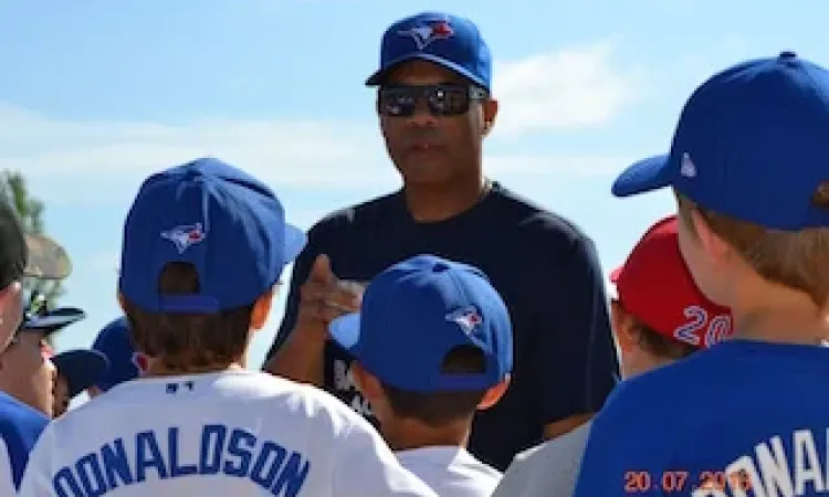 Former Blue Jay Roberto Alomar working with young players at this year's baseball camp