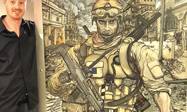 Joe Ashwell poses with his work