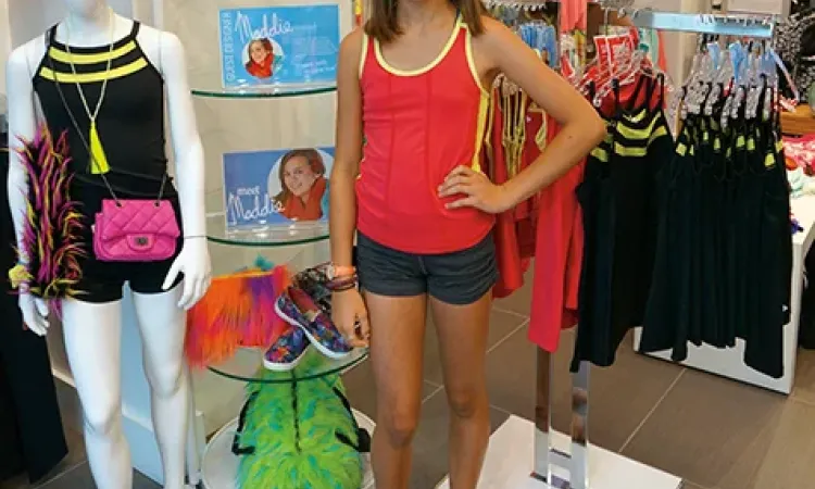 Maddie Thompson alongside her creations at Triple Flip in Winnipeg