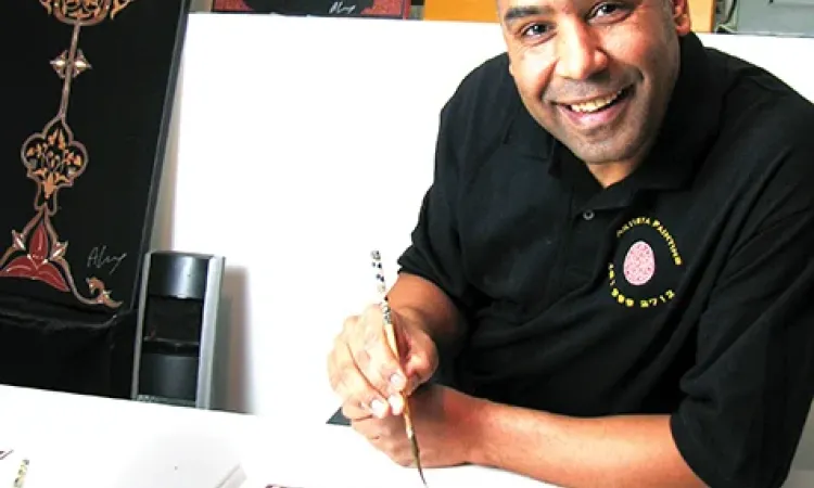 Ahmed Laarissa with some of his Moroccan paintings