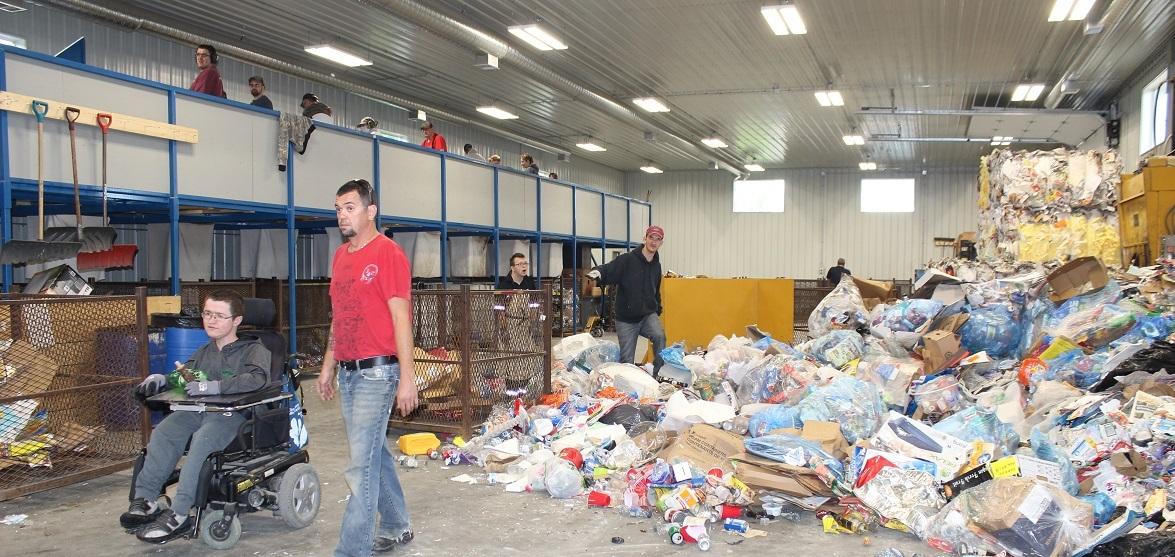 Workers at the SMILE of St. Malo Inc. recycling depot.