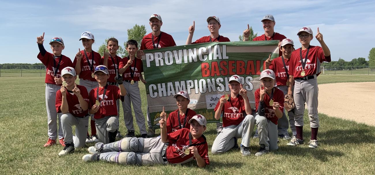 Back row: Mason Dearborn, Kennedy Morissette, Carter Fast, Seth Bunn, Jason Bunn (coach), Clayton Smeltz (coach), Stan Hiebert (coach), Niko Lemoine, and Seth Hooper. Front row: Noah Hudson, Cruze Janz, Jeremiah Martens, Tristan Cousineau, Ben Hiebert, and Ryan Smeltz.