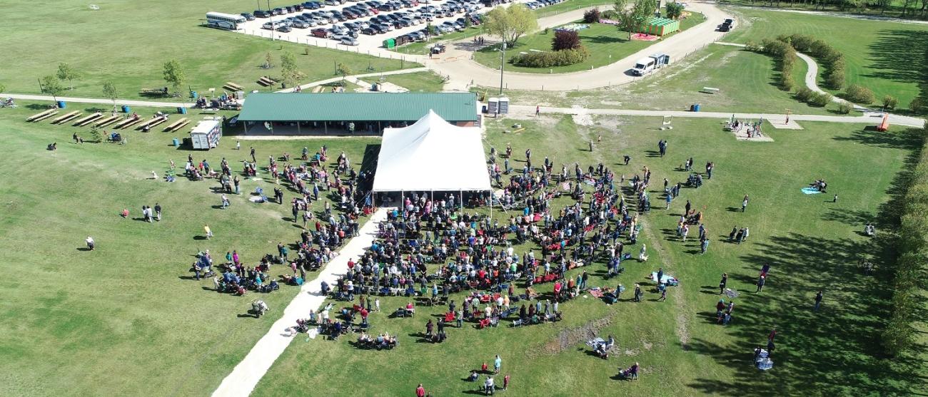Visitors crowd in around the main tent at Niverville 50th anniversary party in Hespeler Park.