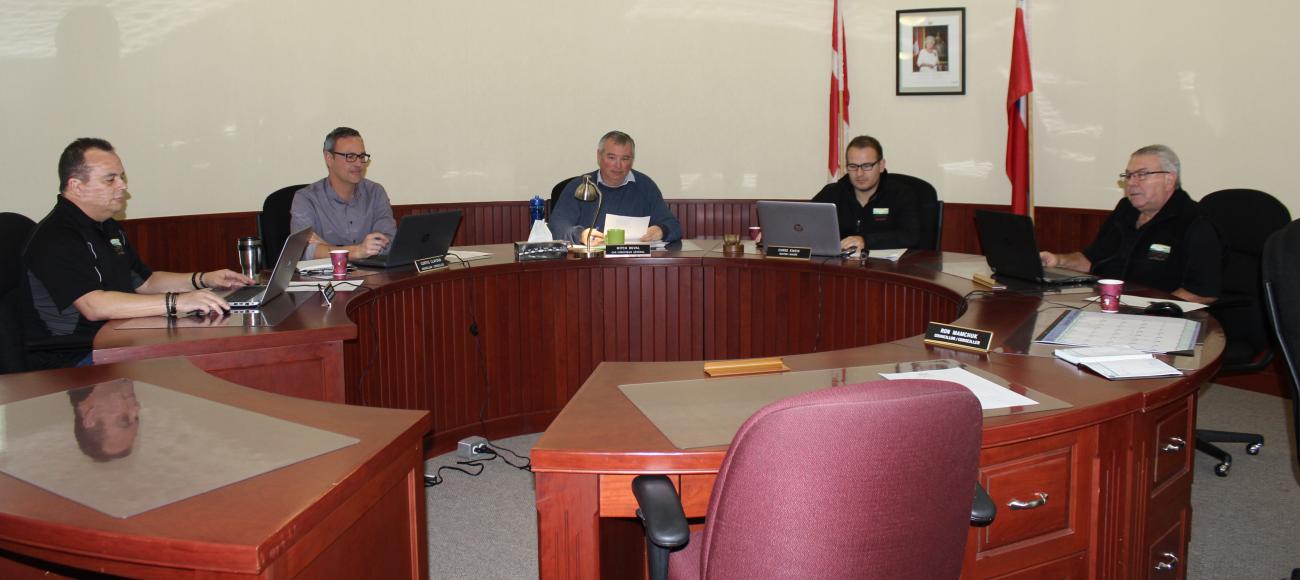 Councillors Shane Pelletier and Curtis Claydon, CAO Mitch Duval, Mayor Chris Ewen, and Councillor Ron Mamchuk. Councillor Janine Boulanger was absent.
