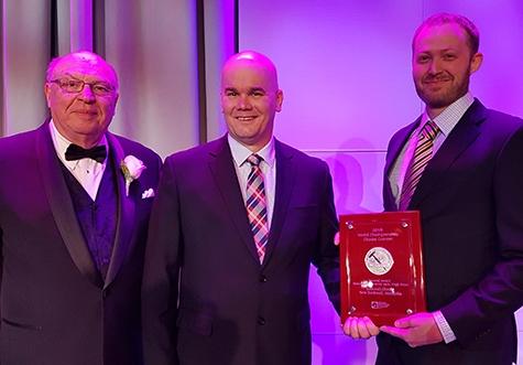 Bothwell cheesemakers Nathan Dueck (centre) and Paul Meyer (right) accept their silver medal.