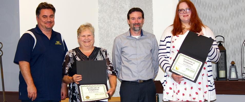 John Magri of the Niverville Chamber of Commerce alongside graduates Deb Brissette, Dave Smith, and Taylor Hayward.
