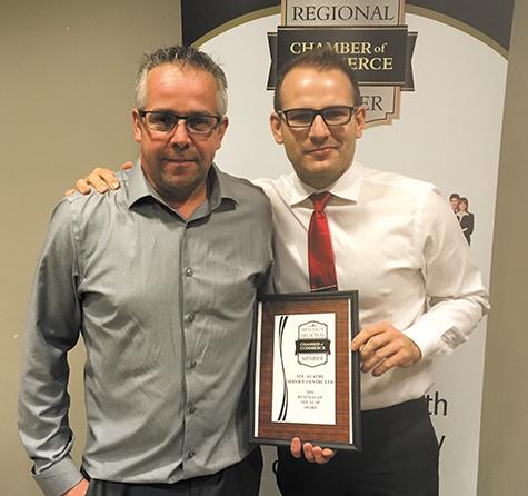 Chris Ewen (right) presents award to Alain Robert, owner of Ste Agathe Service (left