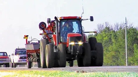 Farm equipment moving along the highway, a common sight from August to October