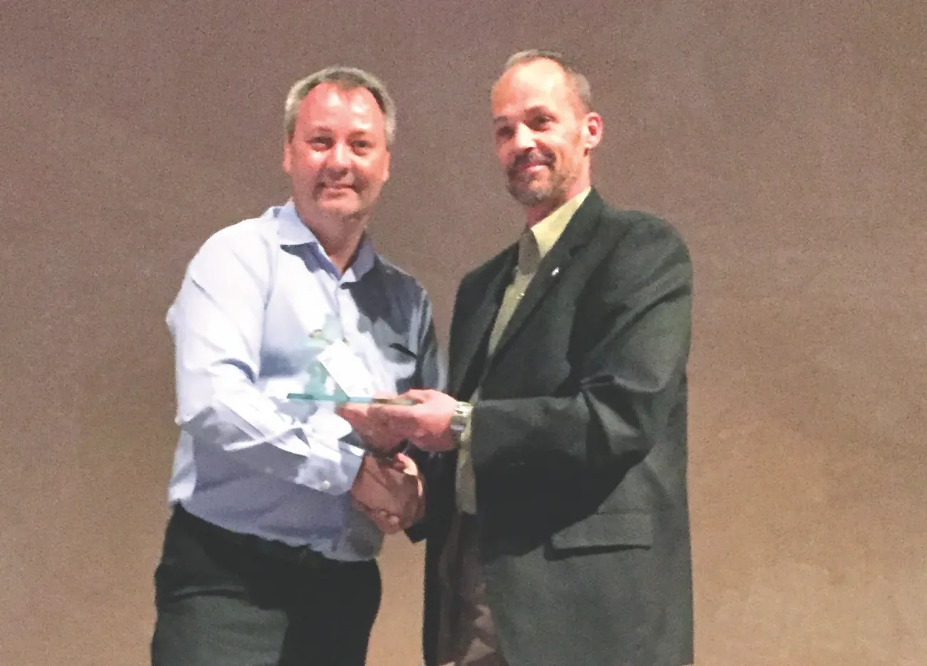 Greg Fehr accepts his award from Jim McMillan