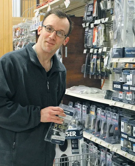 Ryan Becenko stocking shelves at Wm. Dyck and Sons